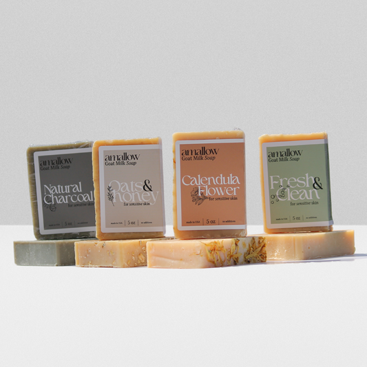 All 4 goat milk soaps shown next to each other, Natural Charcoal, Oats & Honey, Calendula Flower, Fresh  Clean.