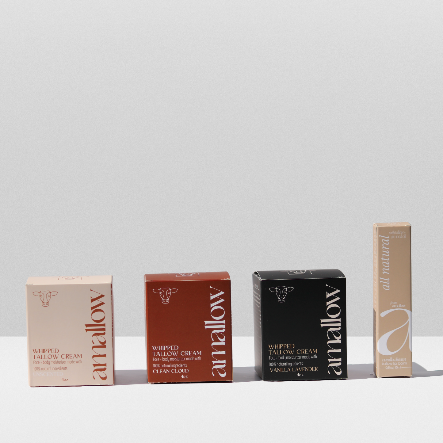 Boxes of Unscented Clean Cloud and Vanilla Lavender products and vanilla dream lip balm shown next to each other.