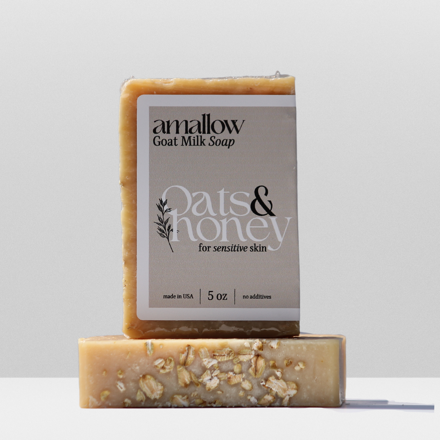 Oats & Honey soap shown. Label Reads "Amallow Goat Milk Soap. Oats & Honey for sensitive skin. Made in USA 5 oz, no additives.