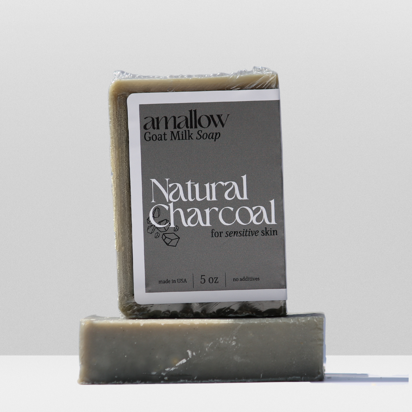 Natural Charcoal soap shown. Label Reads "Amallow Goat Milk Soap. Natural Charcoal for sensitive skin. Made in USA 5 oz, no additives.