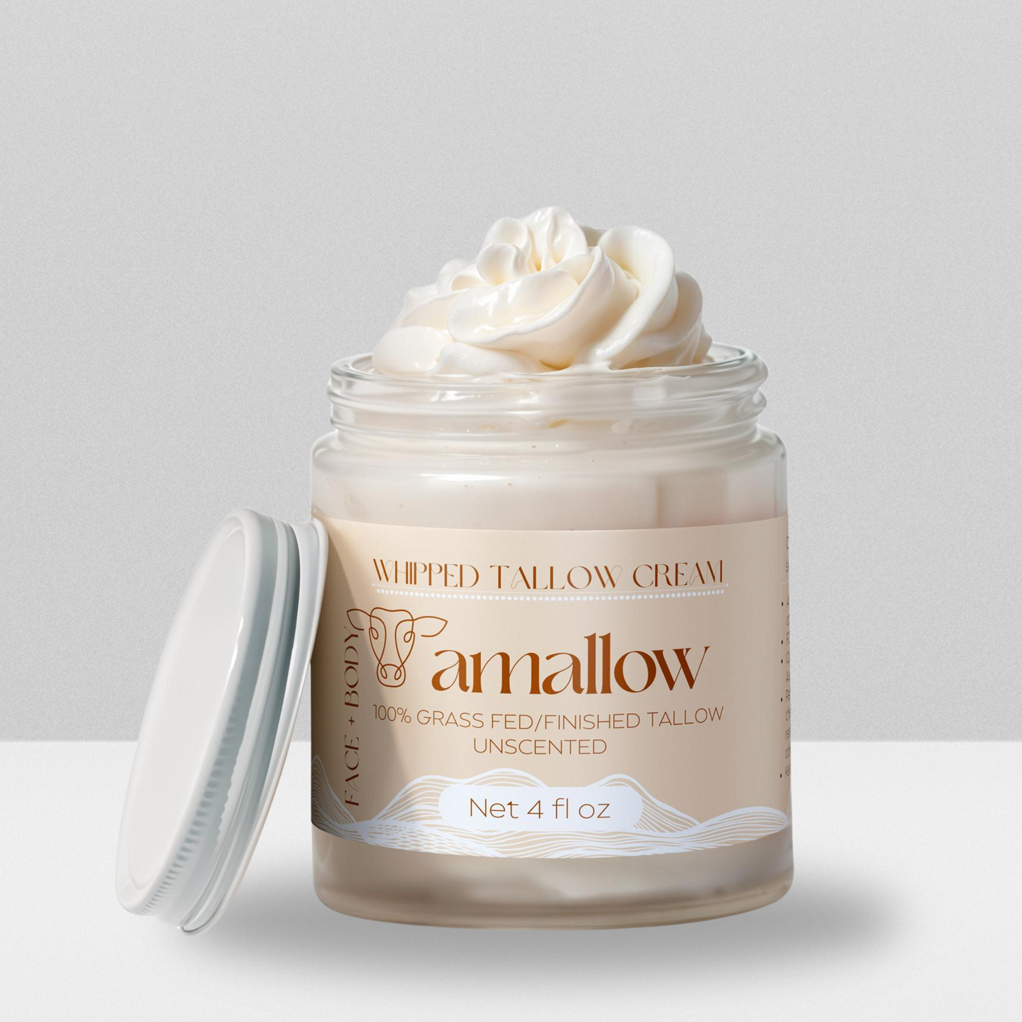 Unscented product shown with cream coming out the top. Label is a cream color. Whipped Tallow Cream 100% grass fed/finished. Net 4 Fluid Oz. Face + Body.