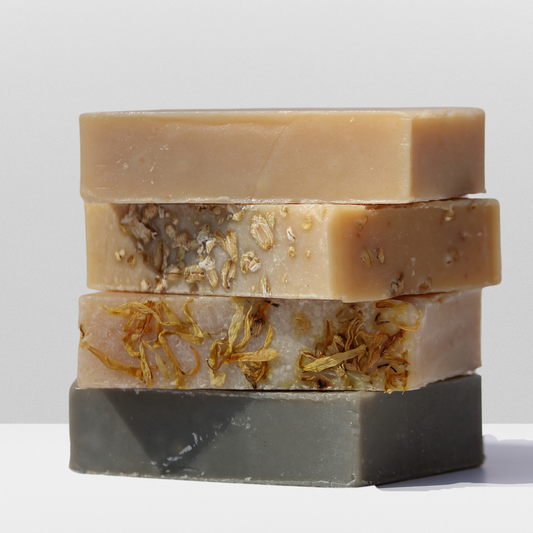 All 4 goat milk soaps shown stacked on top of each other.