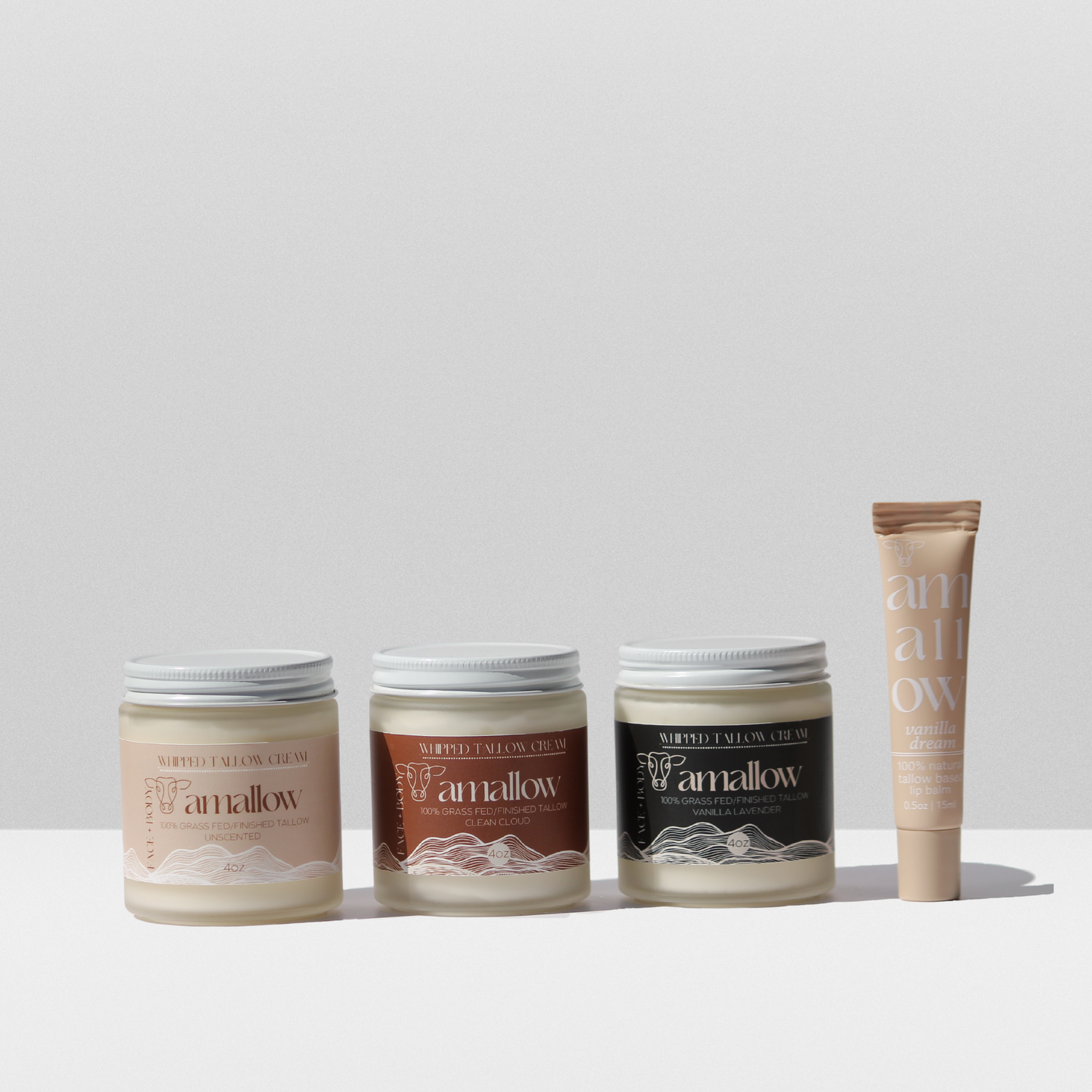 Bundle of Unscented Clean Cloud and Vanilla Lavender products and vanilla dream lip balm shown next to each other. 