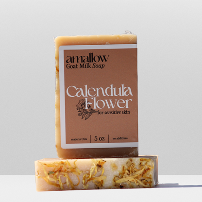 Calendula Flower soap shown. Label Reads "Amallow Goat Milk Soap. Calendula flower for sensitive skin. Made in USA 5 oz, no additives. 