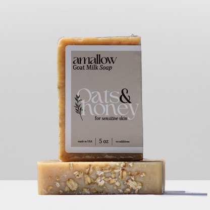 Oats & Honey soap shown. Label Reads "Amallow Goat Milk Soap. Oats & Honey for sensitive skin. Made in USA 5 oz, no additives. 