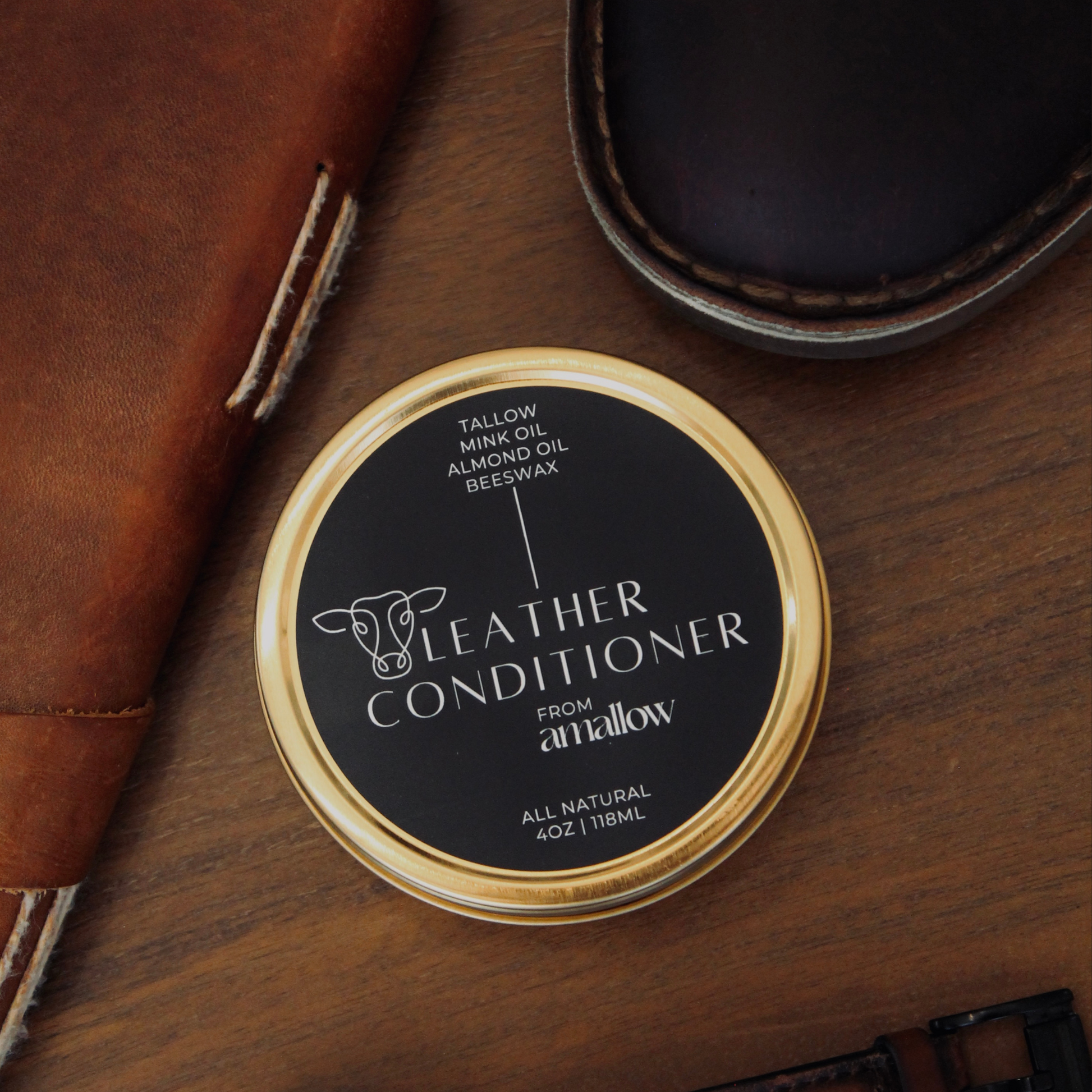 Amallow leather balm tin shown next to a journal and a shoe.