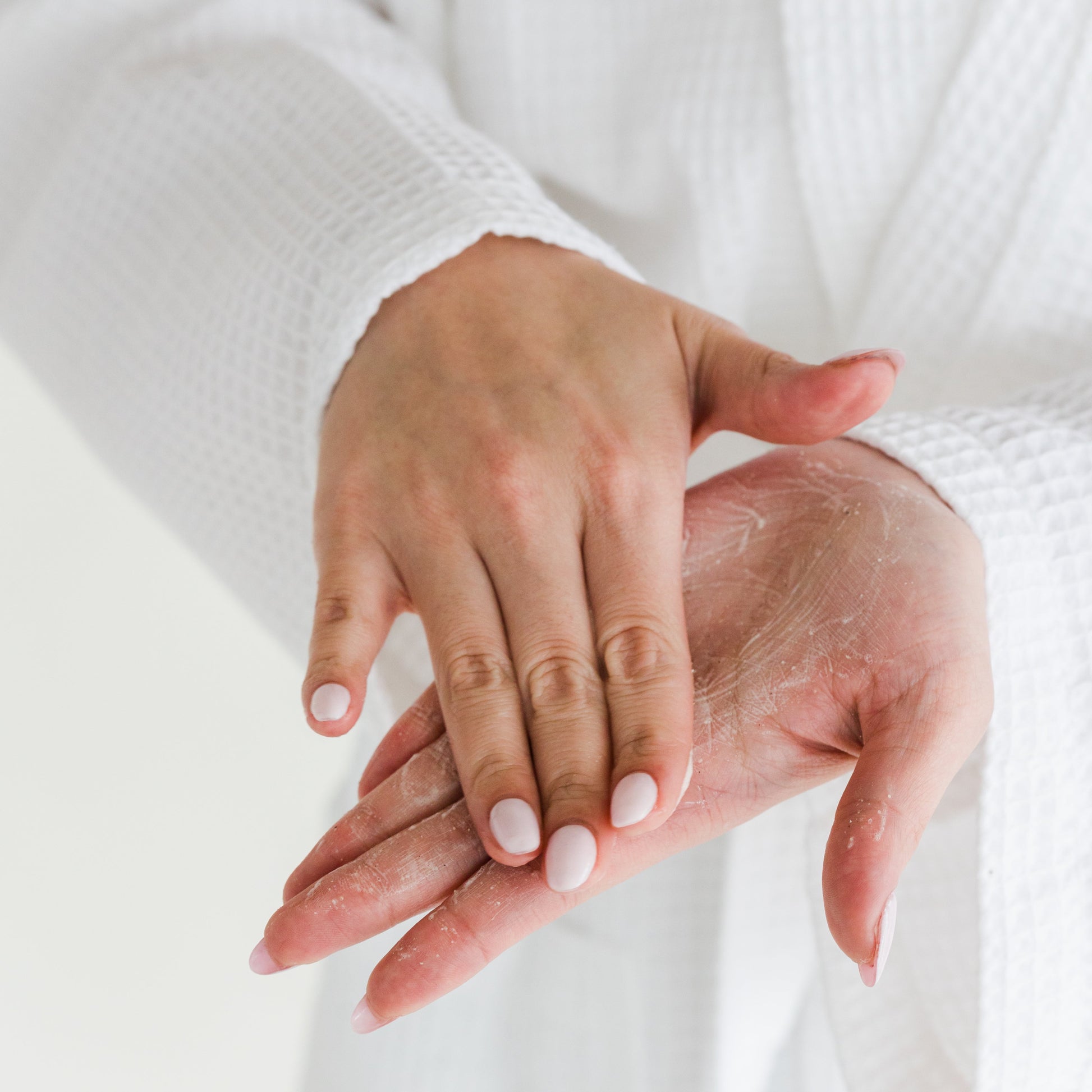 woman lathering powder facial cleanser in hand