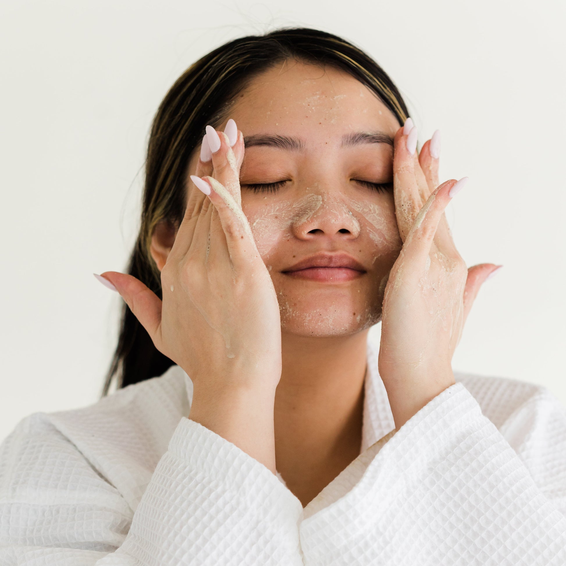 woman washing face with powder facial cleanser