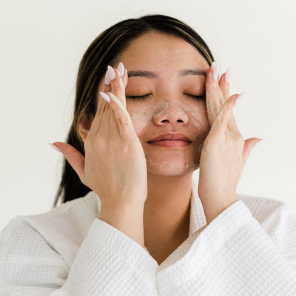 woman washing face with powder facial cleanser