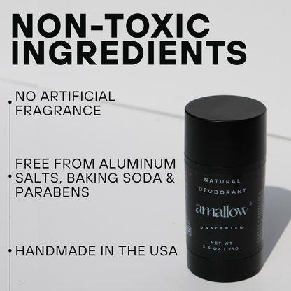 A black cylindrical container of Amallow Unscented Natural Deodorant is shown on a white surface. The label reads 'Natural Deodorant, Amallow, Unscented, Net Wt 2.6 oz | 75g'. Text on the left of the image states: 'Non-Toxic Ingredients', 'No Artificial Fragrance', 'Free from Aluminum Salts, Baking Soda & Parabens', and 'Handmade in the USA'.