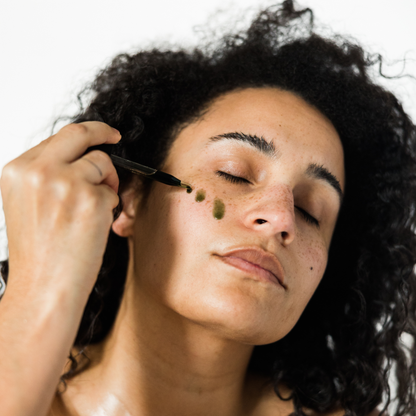 Girl Adding Blue Tansy Serum To Face 