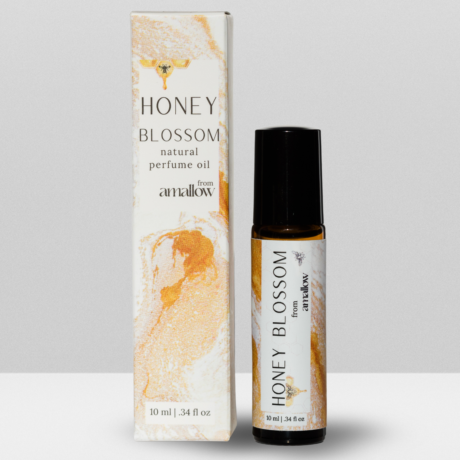 Honey Blossom Perfume Roller Pictured. Next to box. Box states Honey Blossom Natural Perfume oil from Amallow 10ML, .34 fluid oz. Roller says Honey blossom from amallow 10 ML .34 fluid ounces. 