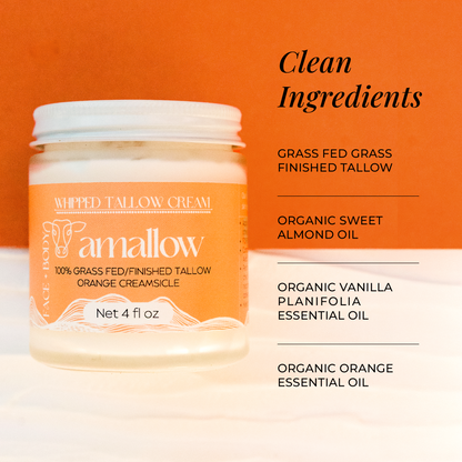 Clean Ingredients - Grass Fed Grass Finished Tallow Organic Sweet Almond Oil, Organic Vanilla Planifolia Essential Oil, Organic Orange Essential Oil. Jar of Orange creamsicle shown next to latte and coffee beans. 